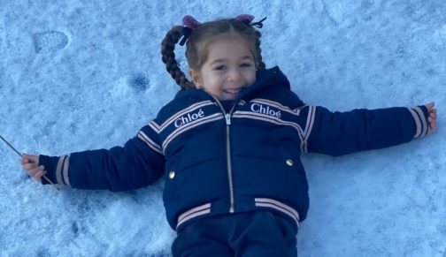 girl making a snow angel