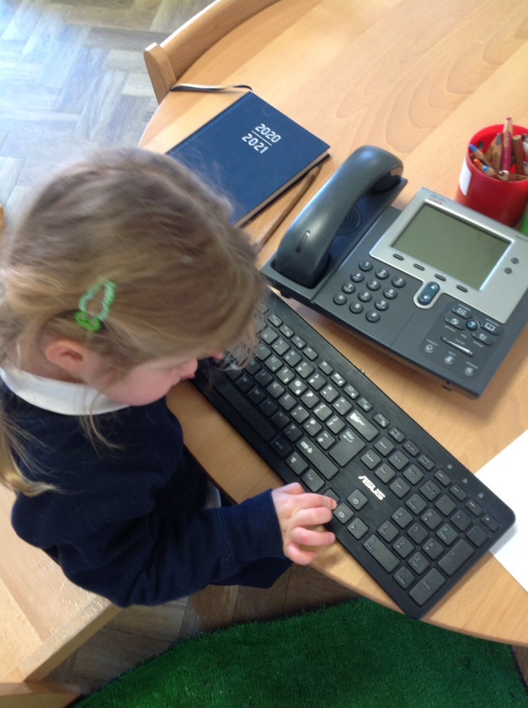 Nursery pupil on a keyboard and phone