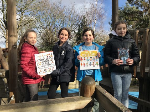 Girls holding donated books