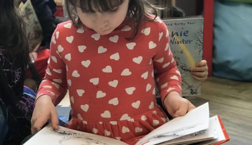 Reception girl reading book